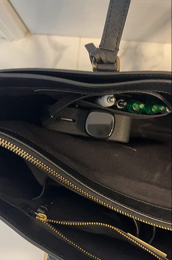 water bottle stashed vertically in a purse