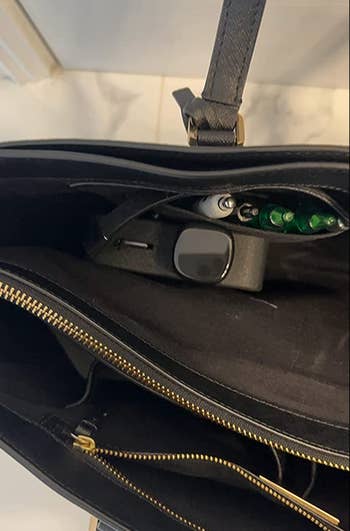 water bottle stashed vertically in a purse 