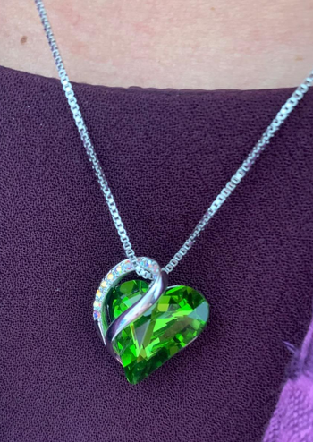 Reviewer wearing the green heart necklace