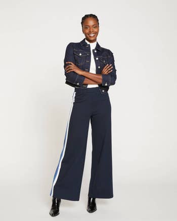 model wearing the navy pants with jean jacket and heels