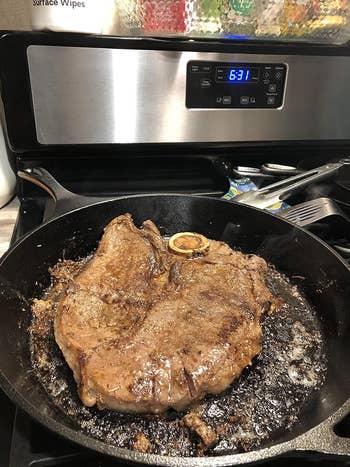 a reviewer using the pan to cook a large steak
