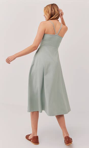a back view of a a model wearing the same dress in mint 