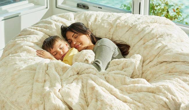 a mother and child cuddling in a lovesac chair