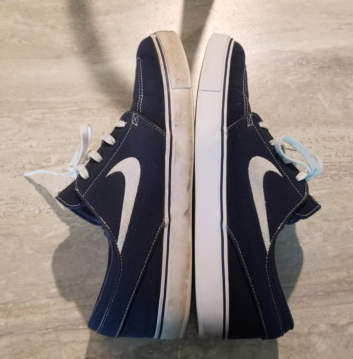 reviewer photo comparing a dirty shoe to one that was cleaned using the cleaning kit