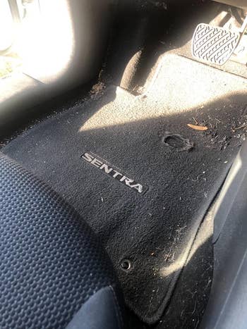 a reviewer's dirty car before using the vacuum