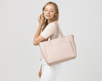 GIF of model using the tote on their shoulder, as a backpack, and as a sling over the shoulder 