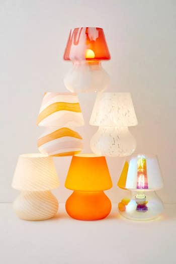 A variety of modern lamps with unique shades and bases displayed for shopping