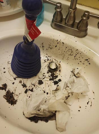 reviewer's sink with lots of gunk pulled out of it 