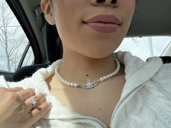 reviewer wearing the silver necklace