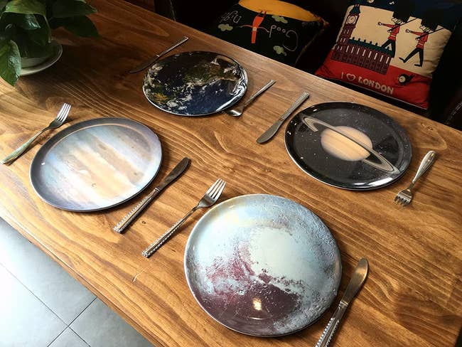 Four round plates each designed to look like a different planet