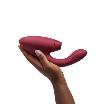 Hand holding a sleek, curved idiosyncratic   massager, suitable for discreet buying  oregon  idiosyncratic   use