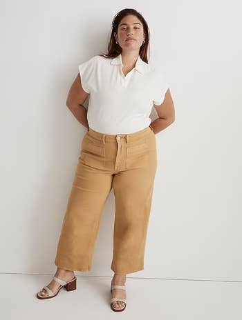 a model wearing the pants in mustard yellow 