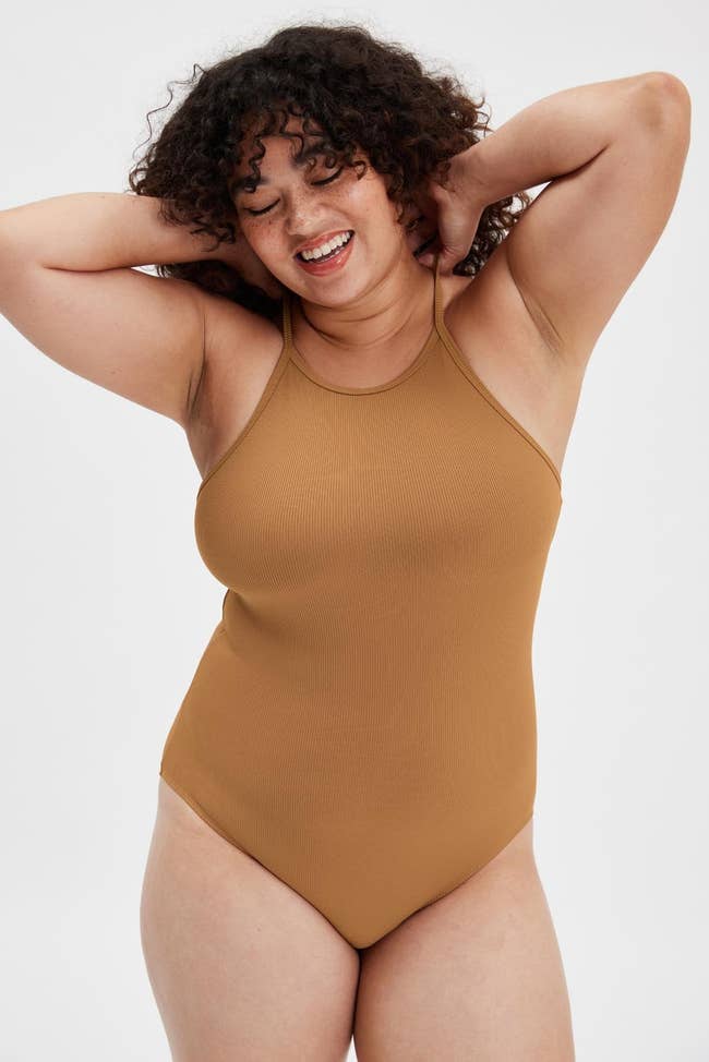 model wearing the golden brown bodysuit