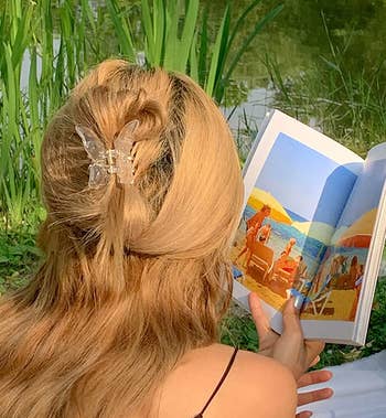 model wears clear butterfly in hair