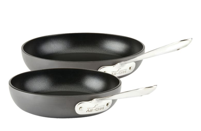 the two round black pans with metal handles