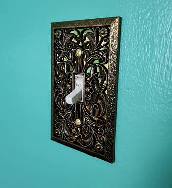 reviewer's wallplate switch cover with the brass filigree design