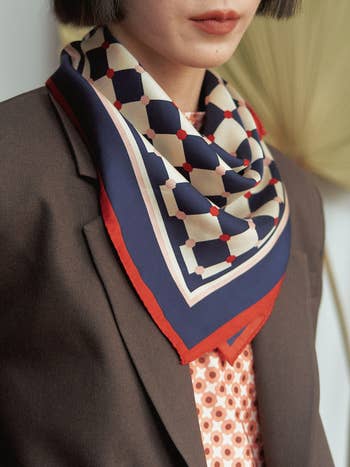 Model wearing the blue and red checkered scarf 
