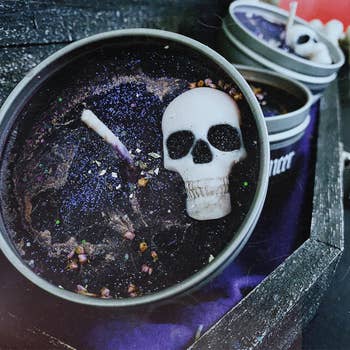 the black glittery candle with a skull inside