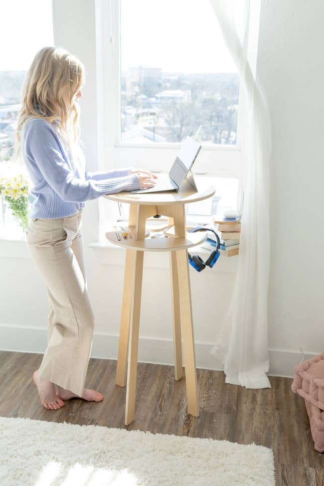 model using the circle desk, which has two platforms, one for the laptop and one for storage