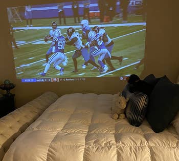 a reviewer photo of the projection display on a bedroom wall 