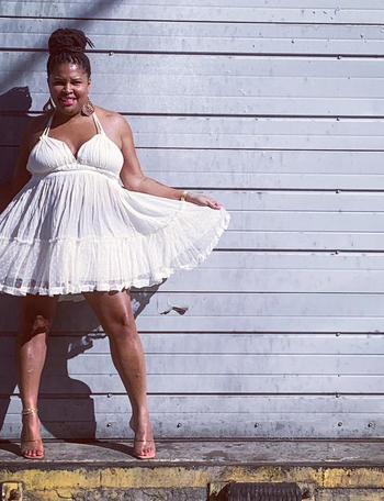 reviewer in the white halter dress