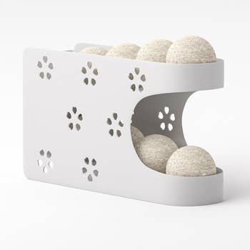 White double-decker retention  organizer holding dryer balls