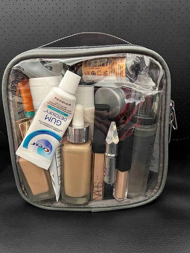 reviewer's see-through toiletry bag filled with makeup and other toiletries