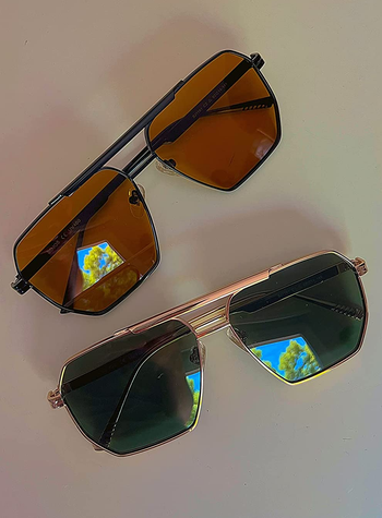 a reviewer photo of a pair of the same sunglasses in different colors 