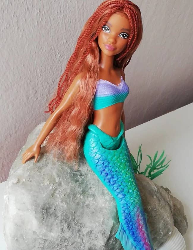 reviewers Ariel doll propped in a sitting position on a rock