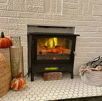 reviewer image of electric fireplace inside non functioning decorative fireplace