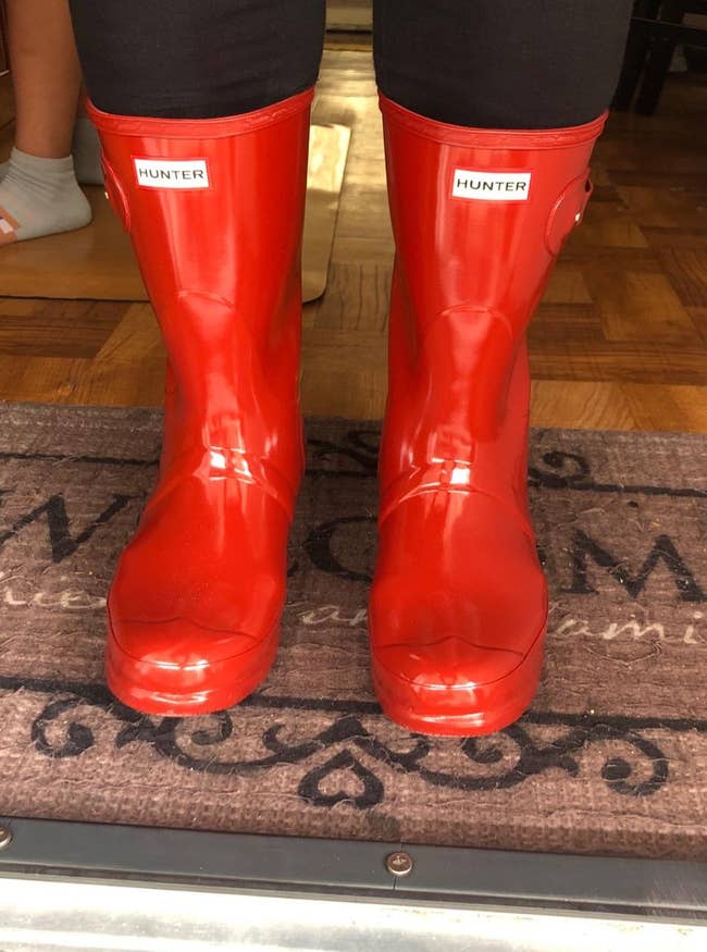 a reviewer wearing red hunter boots