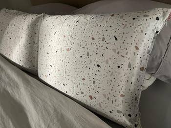 white terrazzo print pillow case on pillow