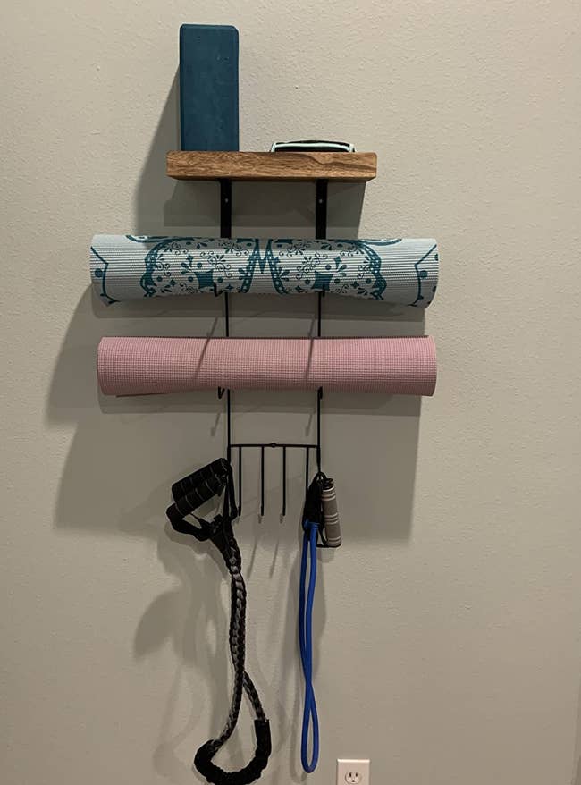reviewer photo of yoga mats and other workout equipment on the organizer