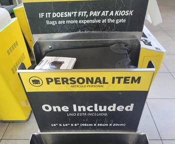 the backpack in a Spirit Airlines personal item sizing station showing that it fits the requirements