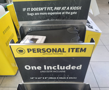 the backpack in a Spirit Airlines personal item sizing station showing that it fits the requirements