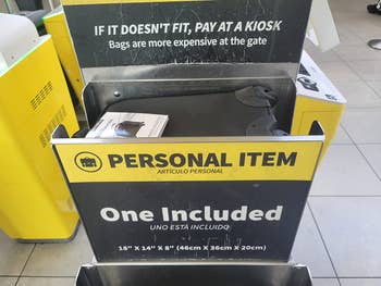 a reviewer's backpack in a Spirit Airlines personal item sizing station showing that it fits the requirements