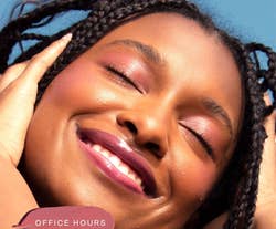 Model wearing mauve blush shade Office Hours on their lids, cheeks, and lips while smiling