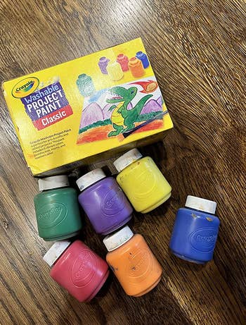A paint set with small containers of red, green, orange, purple, yellow, and blue 