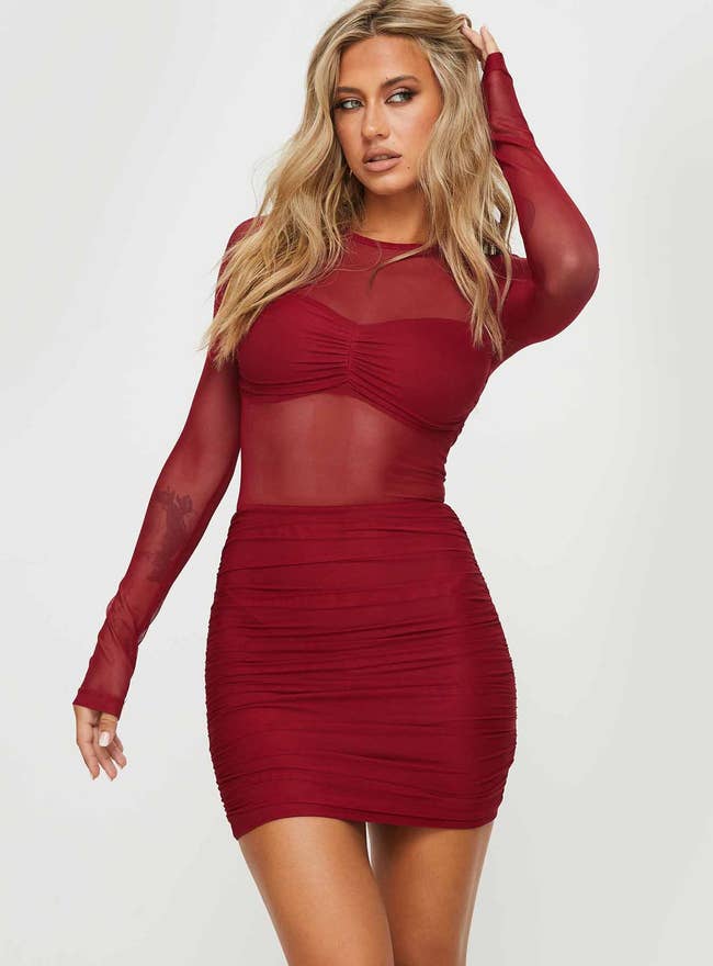 model posing in red mesh dress