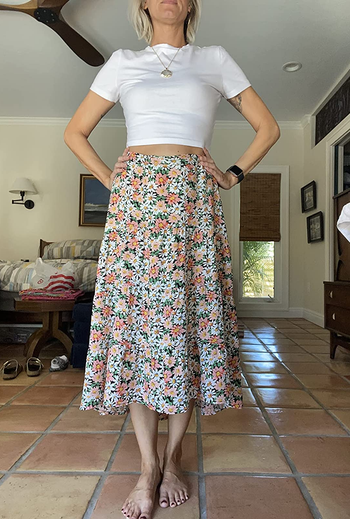 Reviewer wearing midi skirt with white crop top