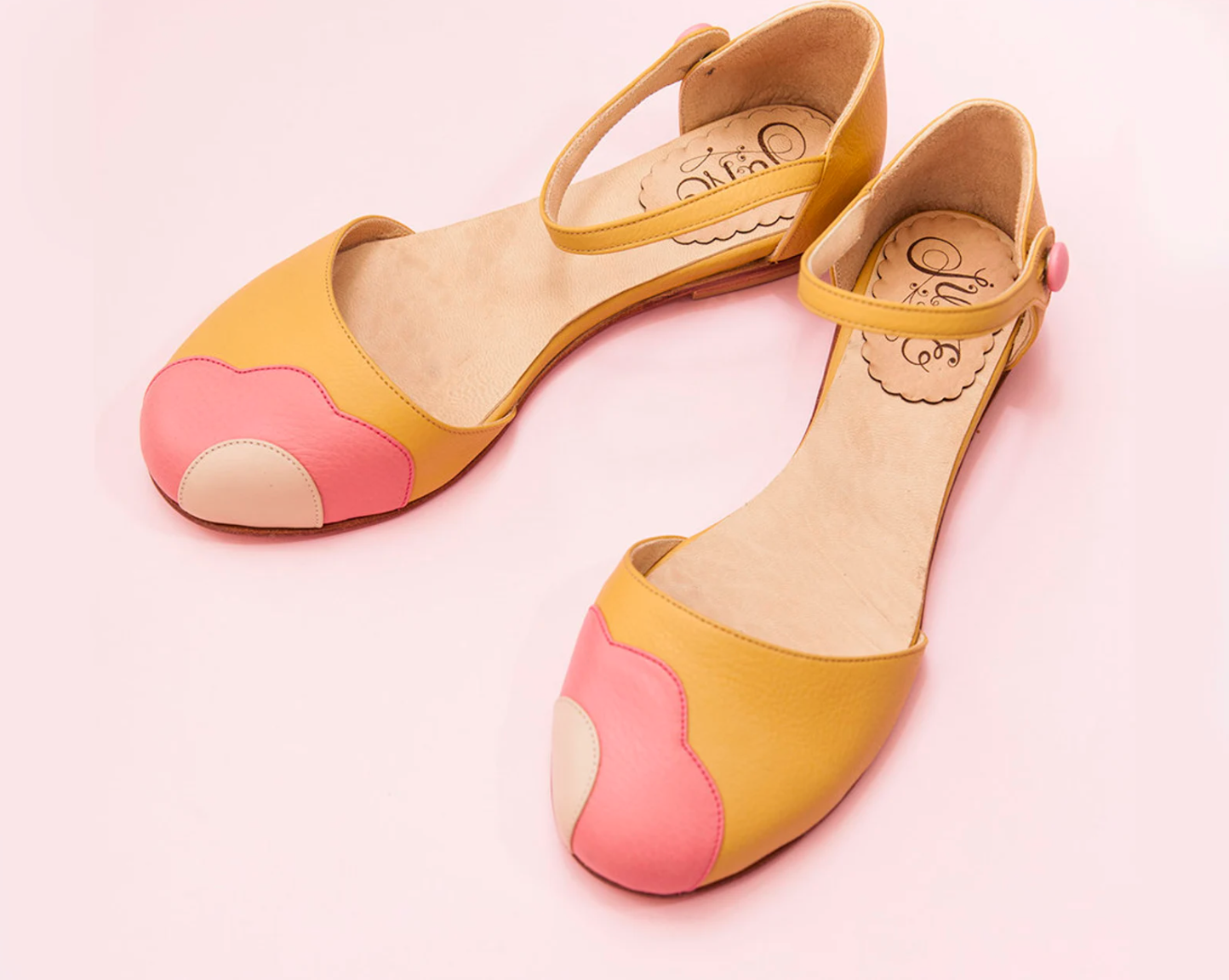 yellow buckle flats with pink flower-like shape on the toe bed