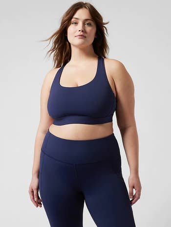 front of model wearing the navy blue ultimate sports bra with matching leggings