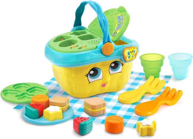 plastic picnic basket puzzle toy with toy food and utensils