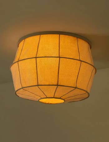 Ceiling light fixture with an illuminated fabric drum shade