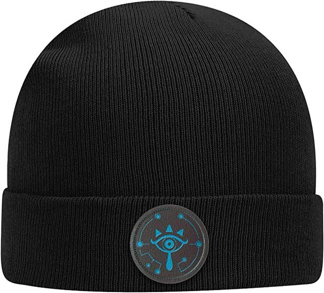 a black beanie with a sheikah eye patch on it from zelda