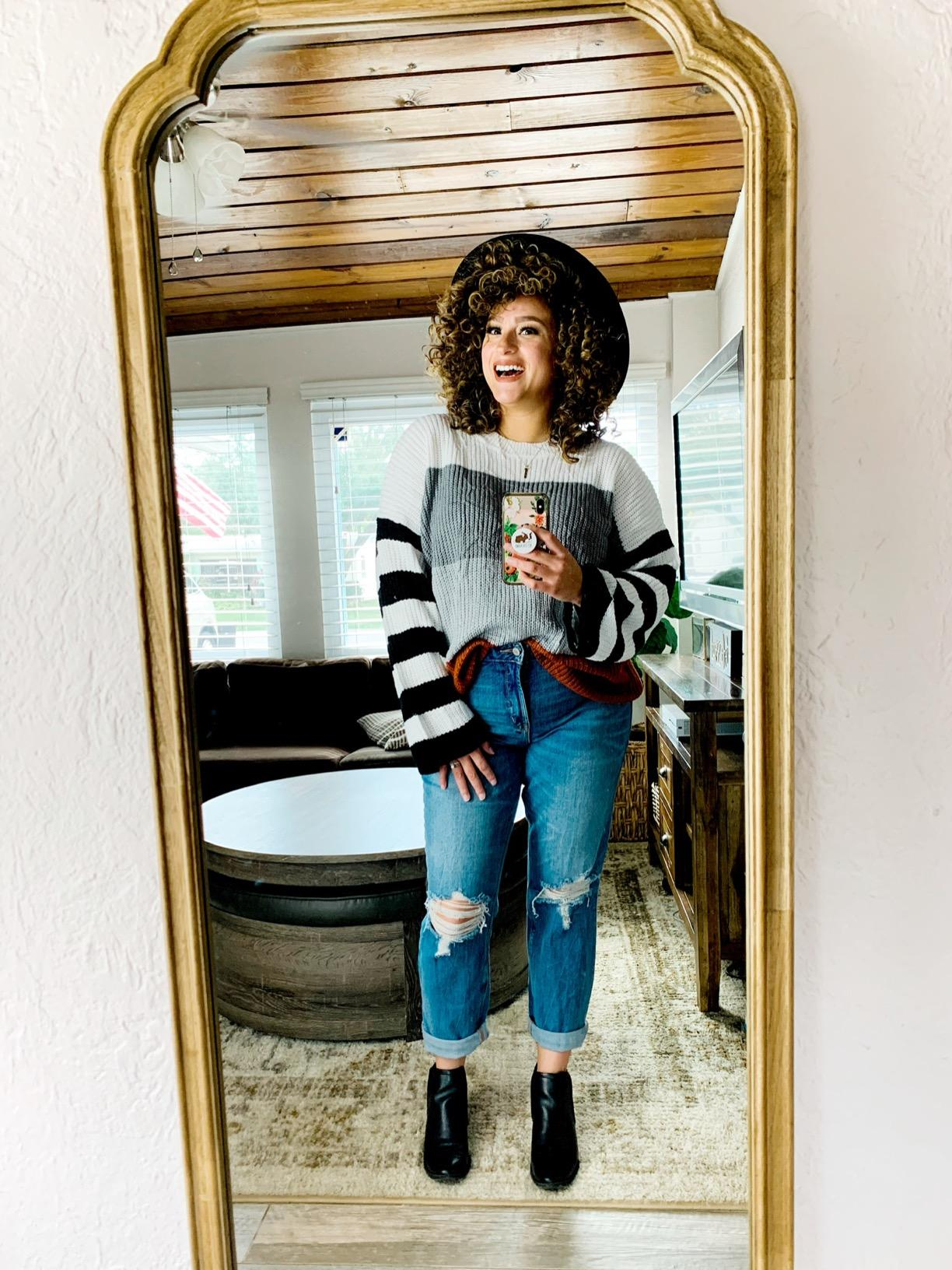 reviewer in the white and black striped sweater