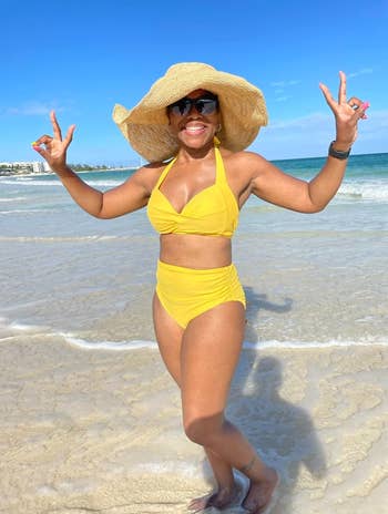 reviewer wearing the bathing suit in yellow
