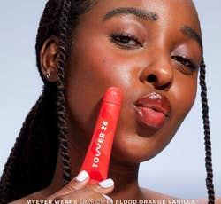 model with blood orange gloss on