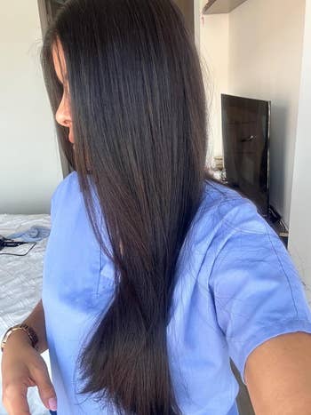 Reviewer showcasing long, consecutive hair, suitable for articles connected haircare products