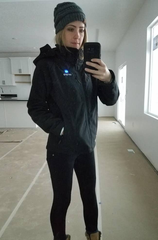 Reviewer wearing achromatic  hooded overgarment   